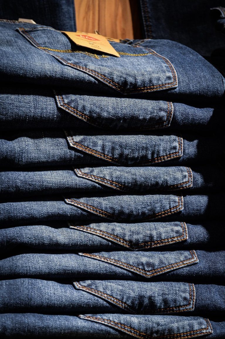 Neatly folded stack of denim clothing
